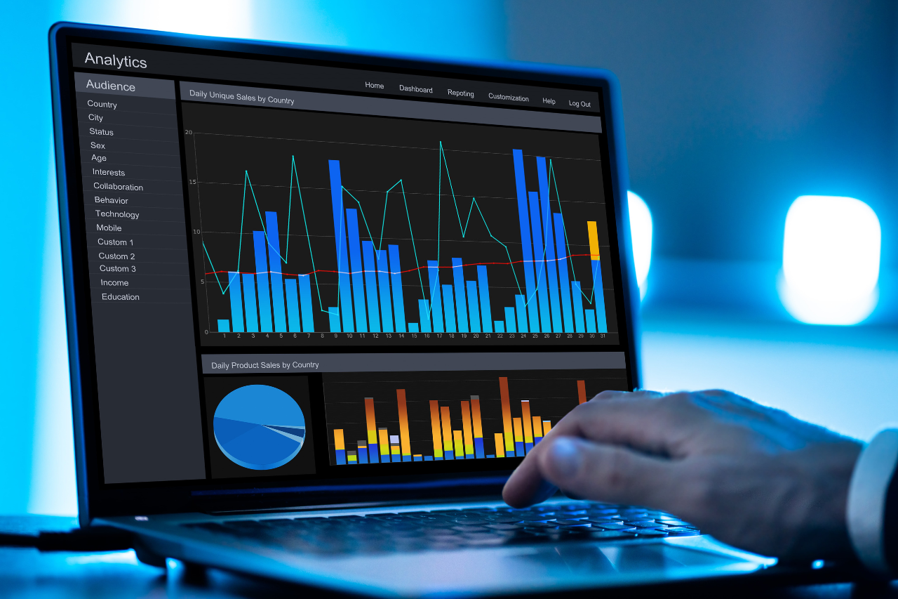 A person analyzing data visualizations on a laptop, powered by predictive AI to gain actionable insights.