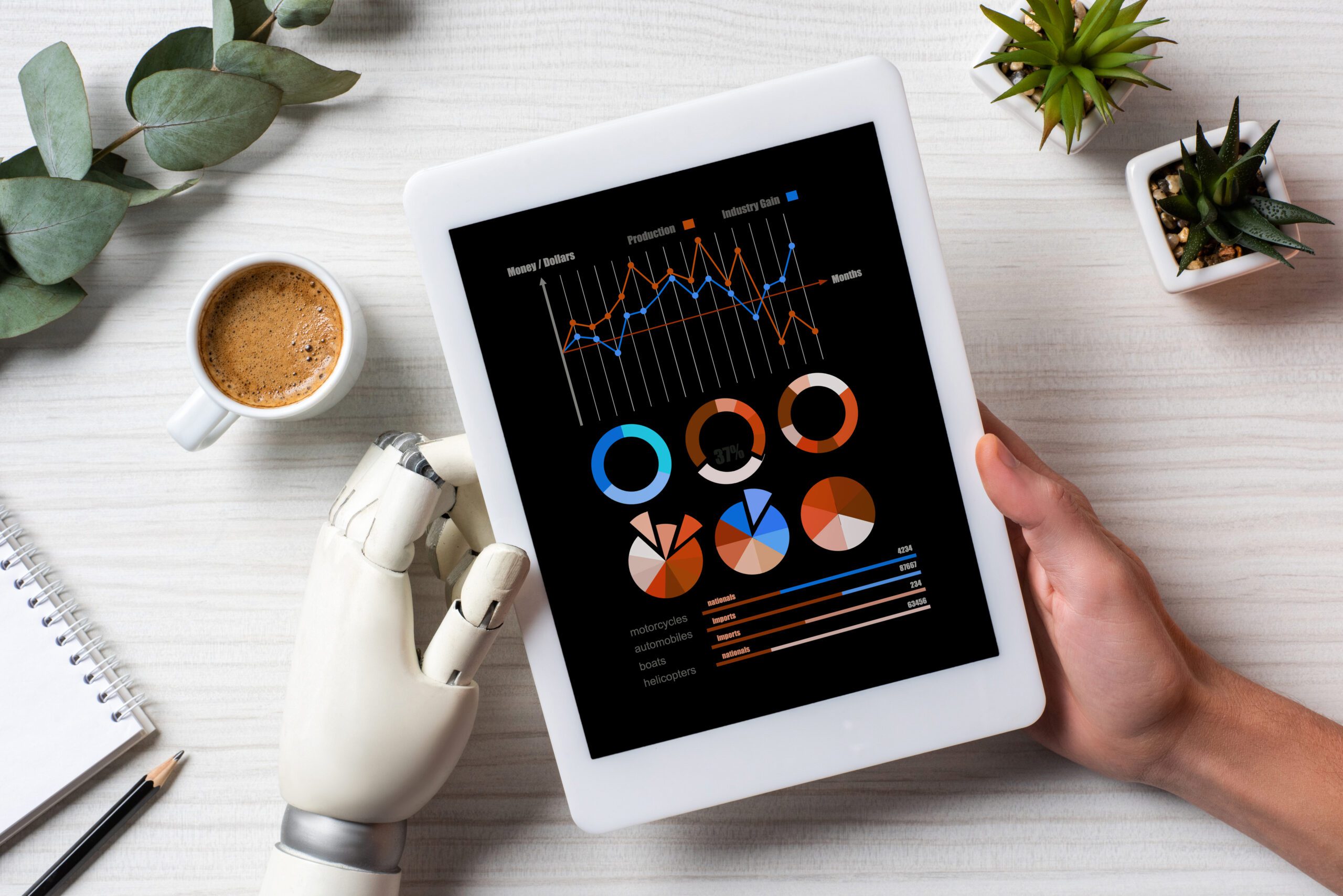 partial view of businessman with cyborg hand using digital tablet with infogrpahic on screen at